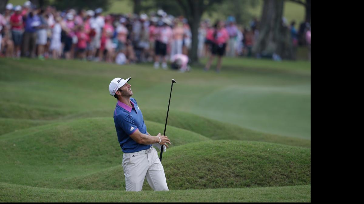 
Dustin Johnson watches his shot from the 18th hole during the final round of The Players Championship.
