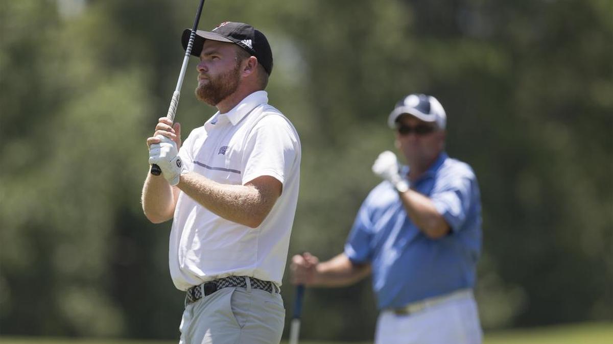 Taylor Bibbs (left) watches a shot while competing with his dad Jeffrey Bibbs of the San Diego area during the 20th National Father & Son Team Classic in 2017 on the Parkland Course at Legends Golf Resort in Myrtle Beach. They finished second overall.