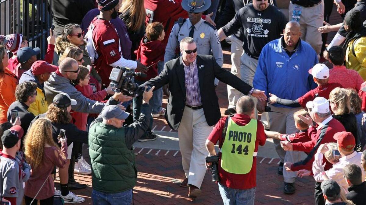 South Carolina coach Shawn Elliott takes part in the Gamecock Walk on Saturday. He ended the day denying his staff has stopped taking commitments from recruits.