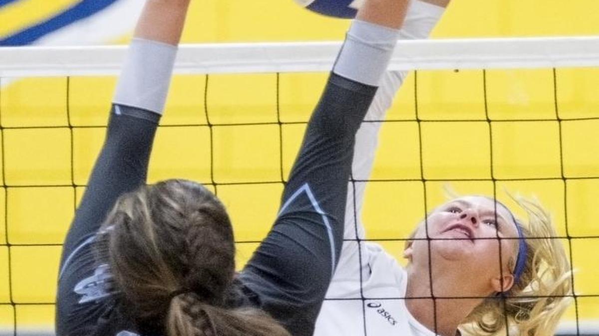 North Myrtle Beach’s Maggie Hash (background) spikes the ball past St. James’ Mallory Farmer during the Chiefs win over the Sharks on Tuesday night.