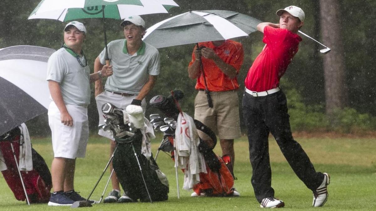 Patrick Golden of Waccamaw High School drives the ball in a down pour during the Class AA state golf championship at True Blue. Golden helped lead Waccamaw to a state championship on the links.