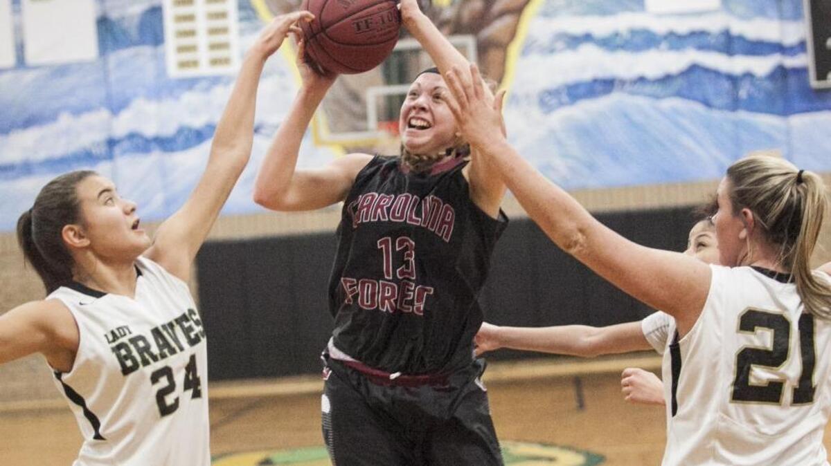 Carolina Forest standout Alexis Tomlin’s shot is contested by a pair of Socastee defenders during a game last season.