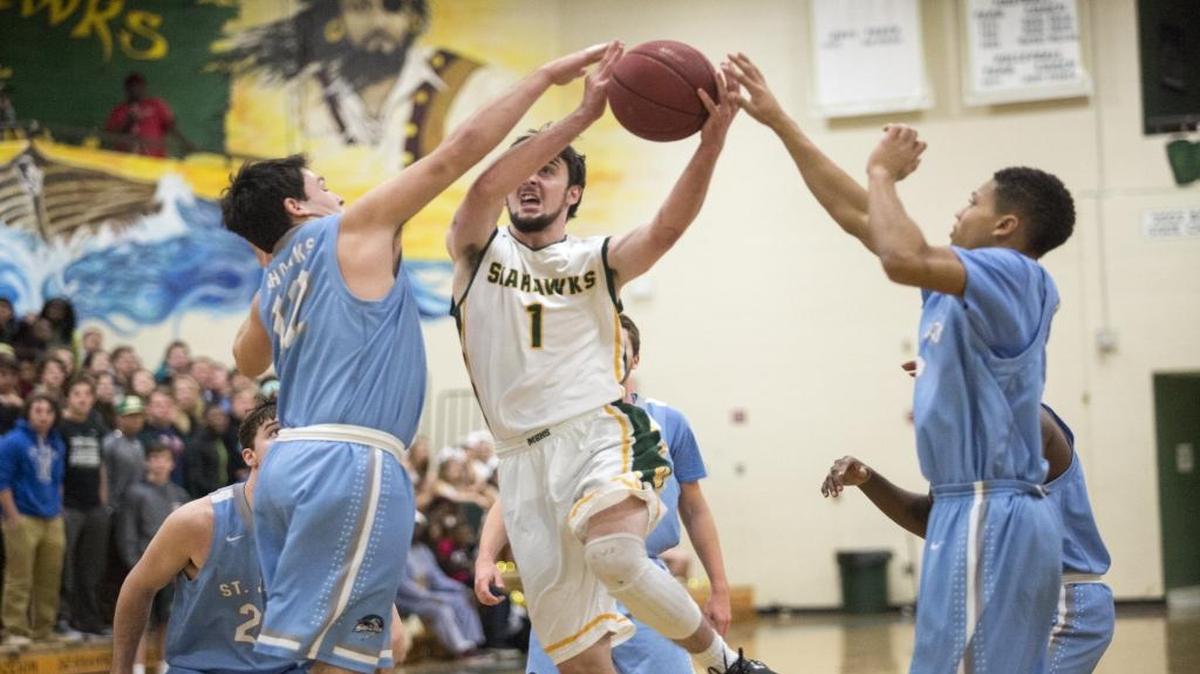 Myrtle Beach’s Adam Zam is blocked by St. James’ Jackson Hurston during a game earlier this season.