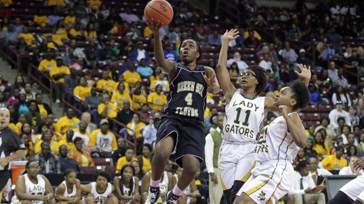 Green Sea Floyds guard Tamara Jackson (4) drives against Estill's Tykeria Jackson (11) and Jonica Jackson (23) in the Class A girls state championship game Friday at Colonial Life Arena in Columbia.