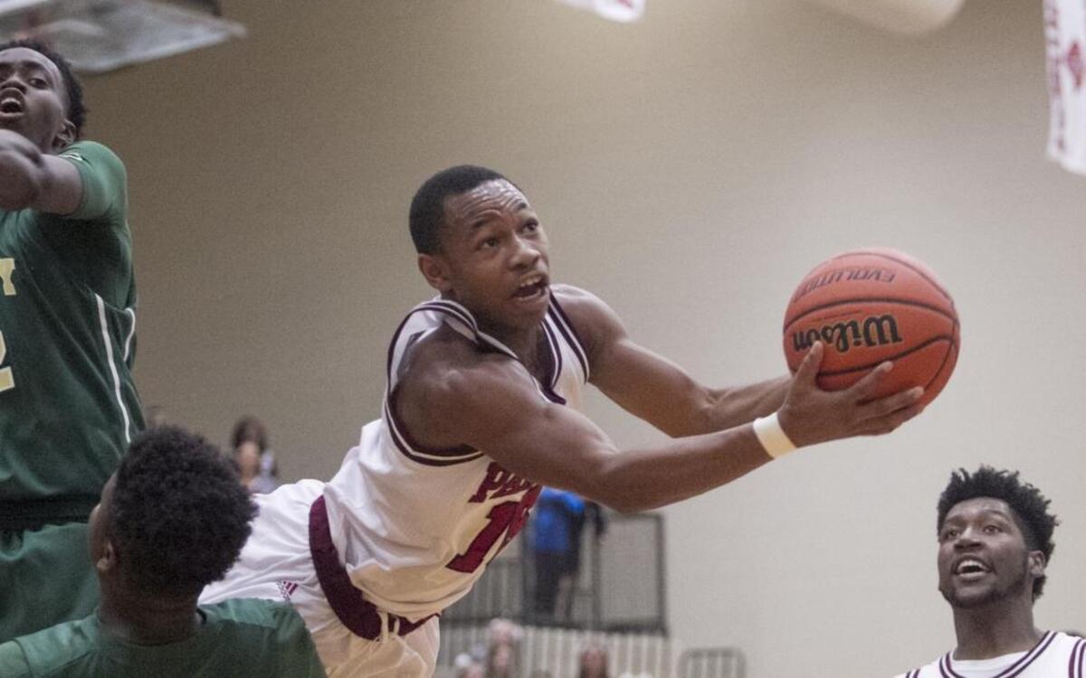 Carolina Forest’s Richmond Collier has his feet knocked out from under him as he shoots while falling to the floor against Conway.