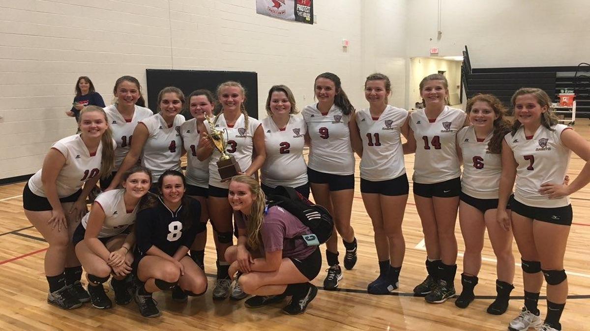 The Christian Academy of Myrtle Beach volleyball team holds the SCISA Class 2A runner-up trophy following its loss to Spartanburg Christian in the championship game.
