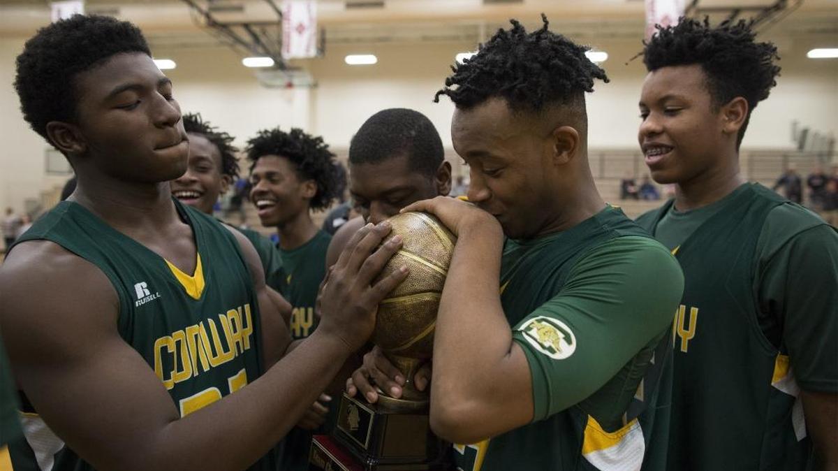 Conway basketball players celebrate after winning the 2016 Panther Classic championship at Carolina Forest High School.