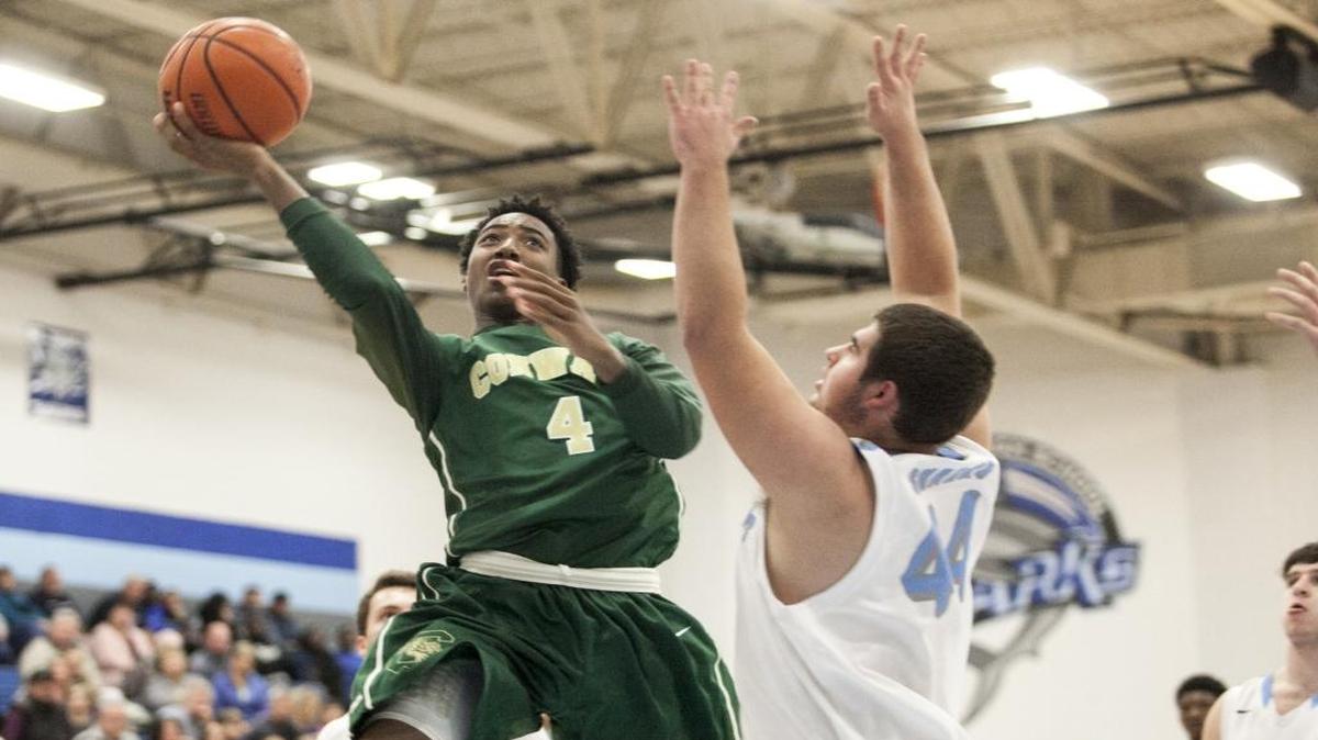 Conway’s Darren Grainger puts the ball up against St. James’ Cole Gallagher.