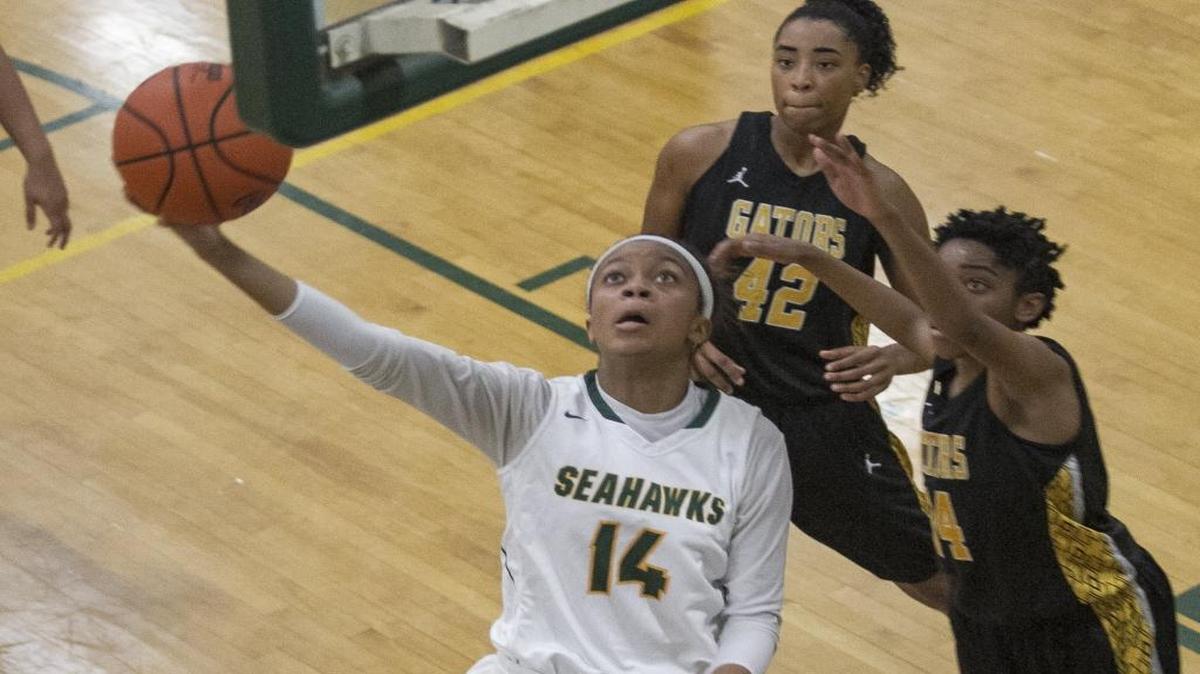 Myrtle Beach’s Nia Sumpter (left) lays the ball up during Friday’s game against Goose Creek.