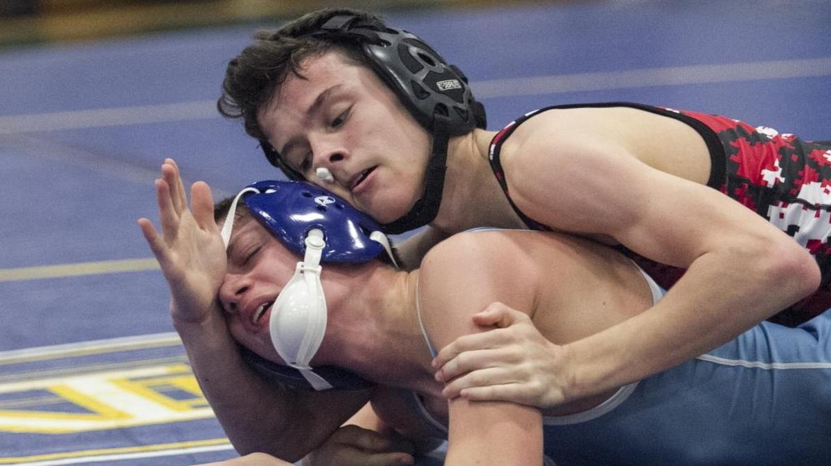 His nose bloodied, Waccamaw’s Caleb McClellan (top) pins St. James’ Billy Goodyear at the inaugural Battle at the Beach.