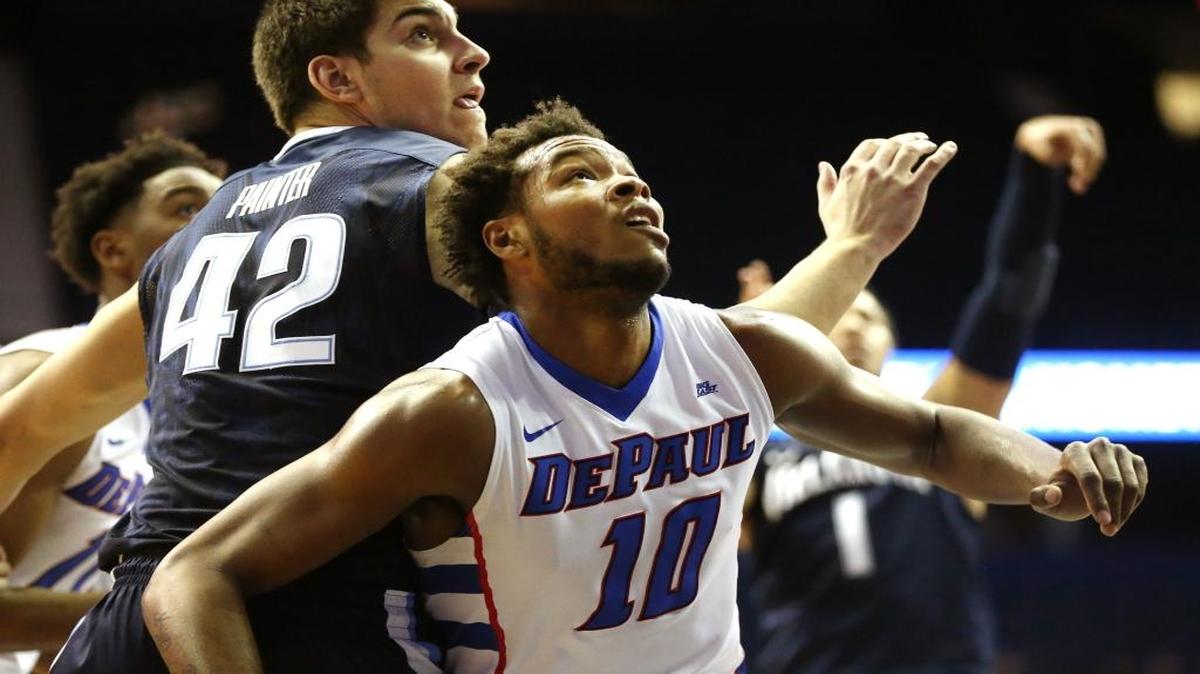 DePaul Blue Demons forward Tre'Darius McCallum (10) and Villanova Wildcats forward Dylan Painter (42) jostle for position under the basket during a game this past season.