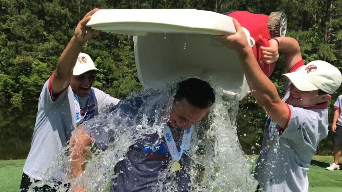 Waccamaw boys golf coach Nate Marozzi is doused by Warrior players after the team claimed its second straight state championship last month at True Blue Golf Club in Pawleys Island, this one at the Class 3A level.