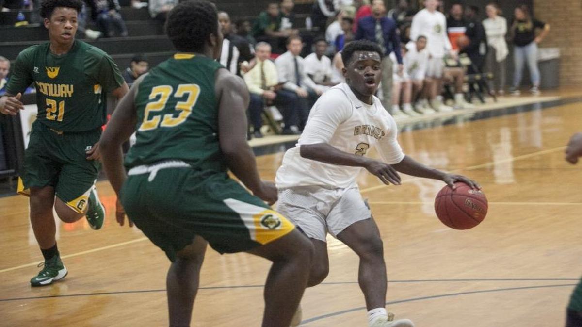 Socastee’s Nijaye Foster drives between Conway defenders during a recent game. His play against rival Carolina Forest helped change the game in the Braves’ favor.