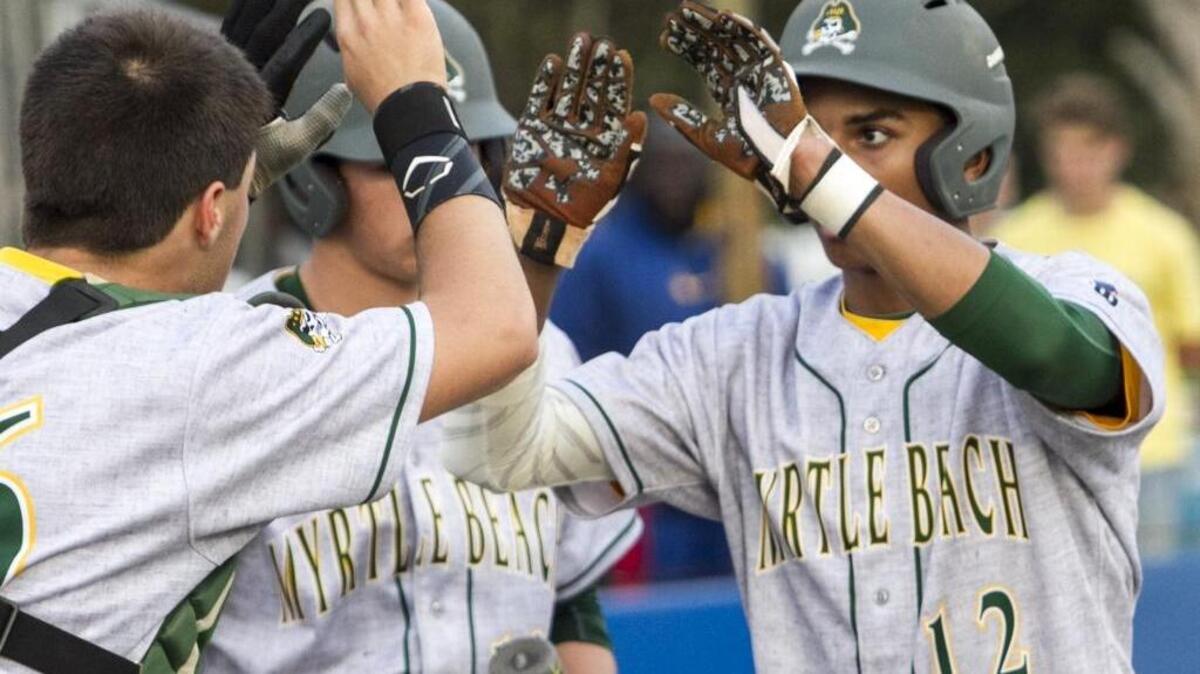 Myrtle Beach’s Jayce Allen is congratulated by teammates after scoring a run against North Myrtle Beach last week.