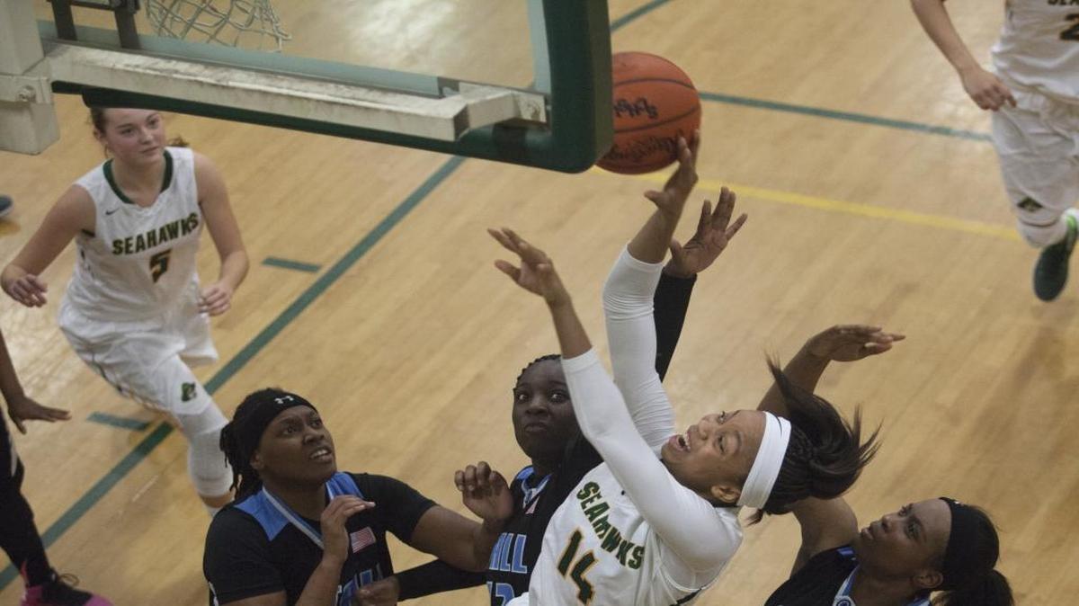 Myrtle Beach's Nia Sumpter is fouled while shooting under the basket against Stall. The Myrtle Beach girls advanced to the third round of the Class AAA state playoffs Thursday night with a 52-34 victory.