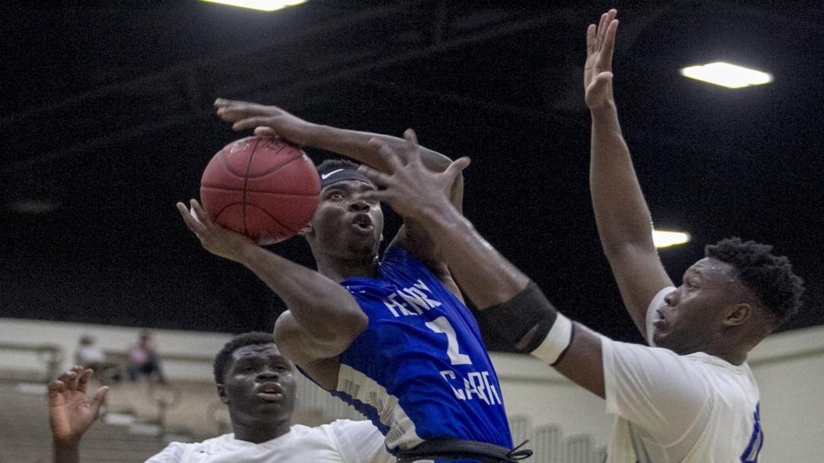 Henry Carr's John Akende drives inside against Dillard.