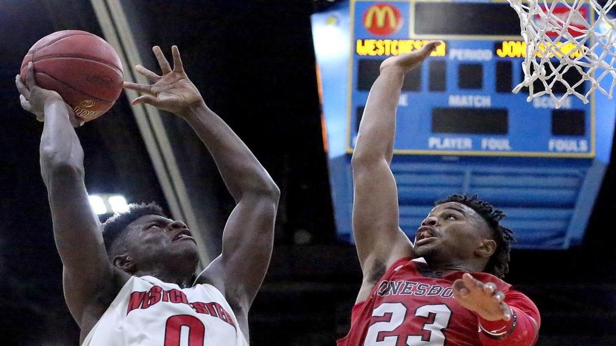 Marquis Moore (0) of Westchester (Calif.) goes up against M.J. Walker (23) of Jonesboro (Ga.) during a first-round game of the Beach Ball Classic at the Myrtle Beach Convention Center.