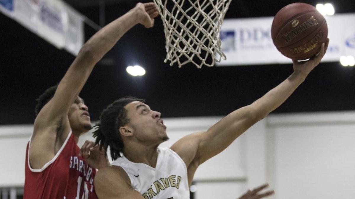 Socastee’s Marcus Hemingway goes up and under for a basket during the Braves’ win over Spartanburg Day on Wednesday at the Beach Ball Classic.