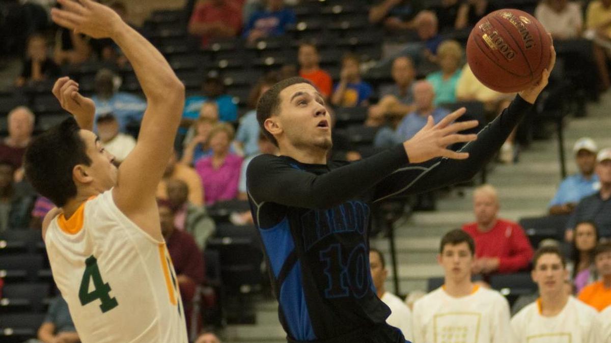 Shadow Mountain’s Michael Bibby (right) goes up for a shot over St. Edward’s Thomas Schmock.