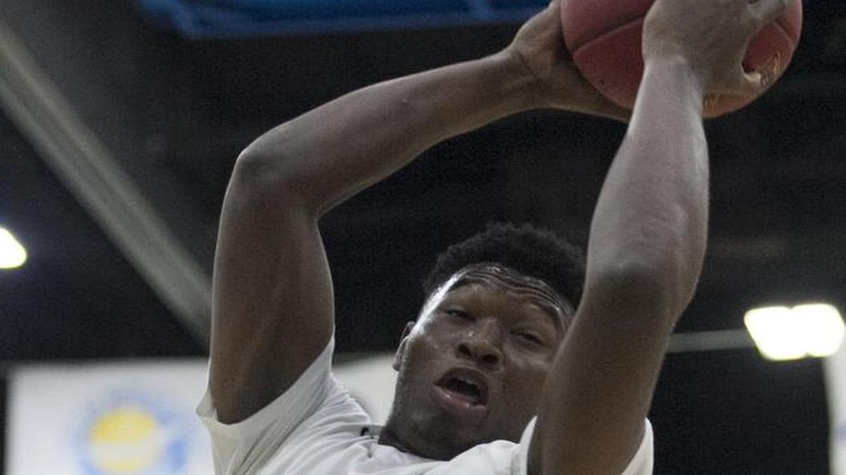 Dillard's Jordan Wright pulls down a rebound against Henry Carr.