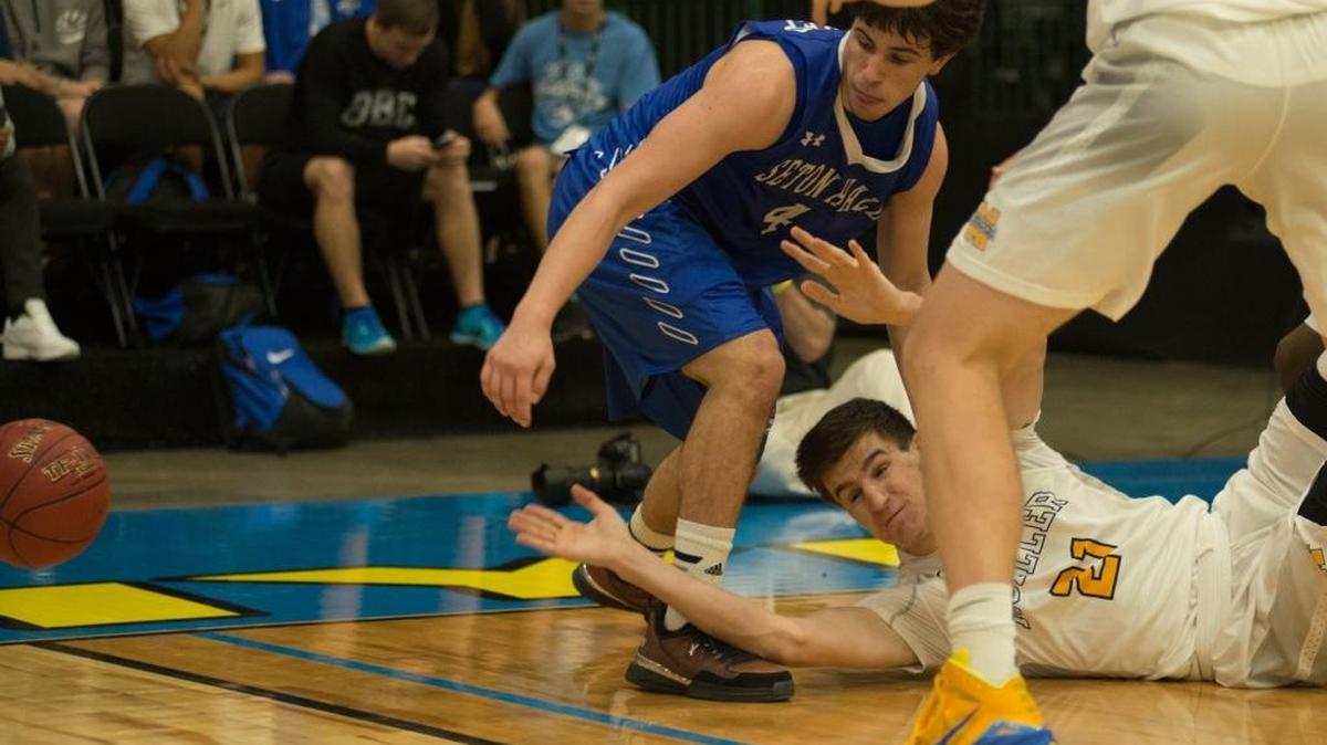 Seatons Hall’s Stephen Ferraro (4) battles Moeller’s Sam McCracken for a loose ball.
