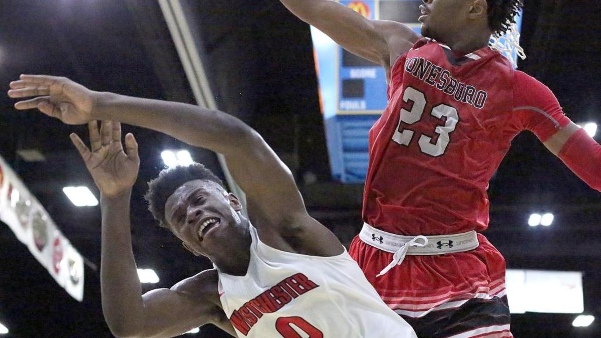 Marquis Moore (0) of Westchester (Calif.) is blocked by M.J. Walker (23) of Jonesboro (Ga.).