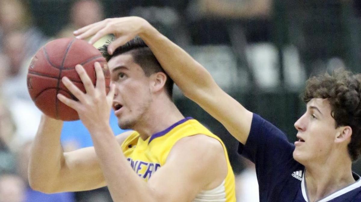 St. Francis’ Drew Smith (right) tries to block a shot by Montverde Academy’s Sean Mobley.