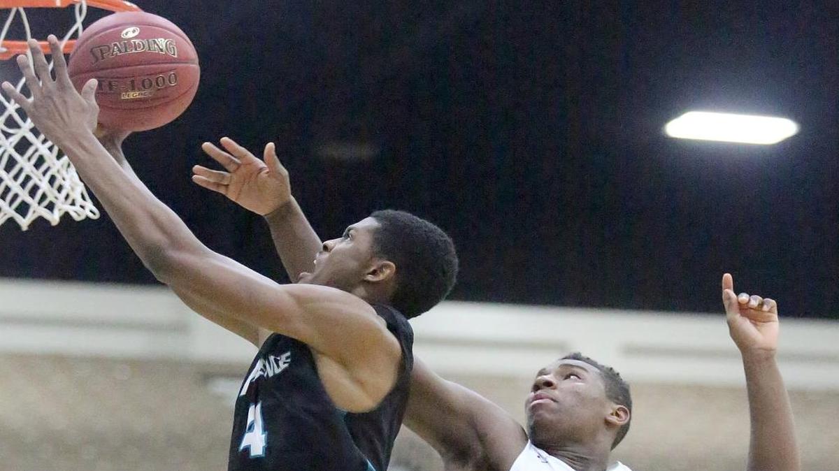 Nieja Jordan (4) of Providence (Fla.) is blocked by Elyjah Williams (21) of Evanston Township (Ill.) in their Beach Ball Classic opener on Monday. Providence rebounded from a one-point loss the day before to down Myrtle Beach on Tuesday, 74-47.