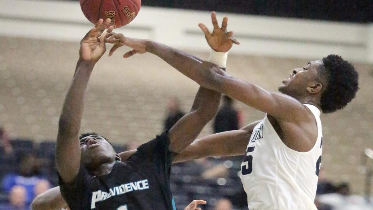 Zackery Bryant (1) of Providence (Fla.) is blocked by Chris Hamil (25) of Evanston Township (Ill.) during Game 3 on Monday.