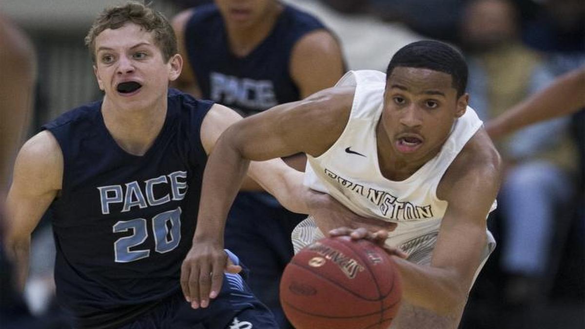 Pace Academy guard Harrison Lewis (20) and Evanston Township guard Malcolm Townsel (4) battle for a loose ball during a Beach Ball Classic semifinal Friday.