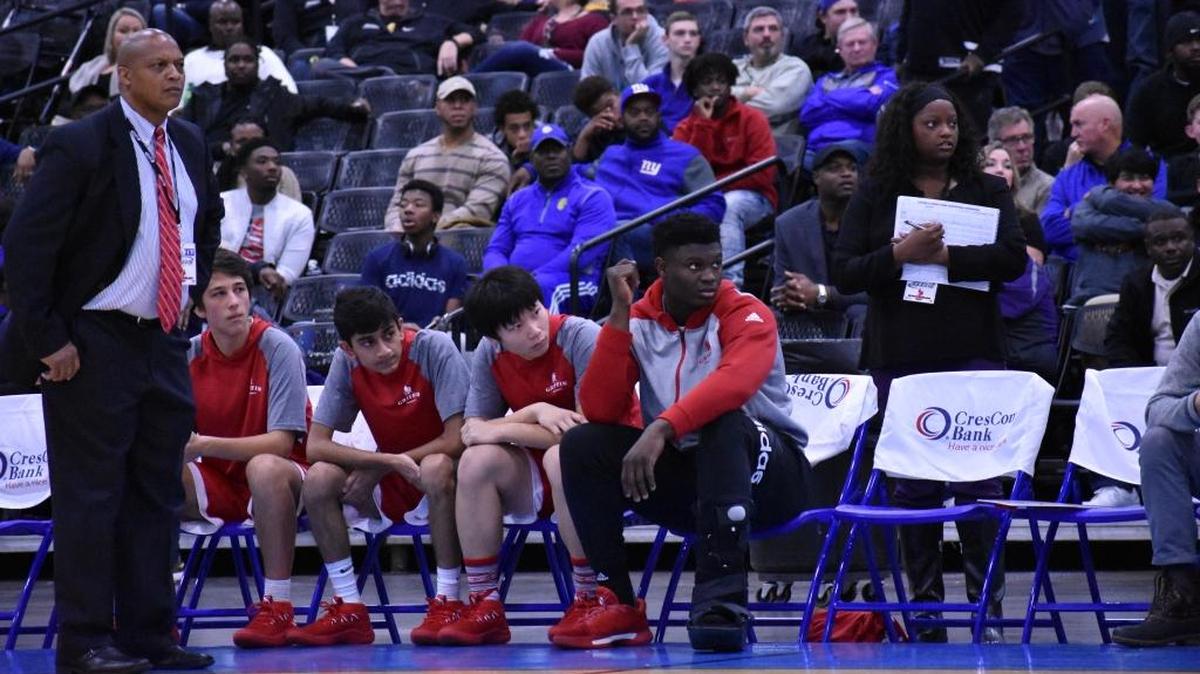 Spartanburg Day basketball coach Lee Sartor (left), top prospect Zion Williamson (right) and other Griffin players look on as their team battles Socastee Wednesday at the Beach Ball Classic in Myrtle Beach.