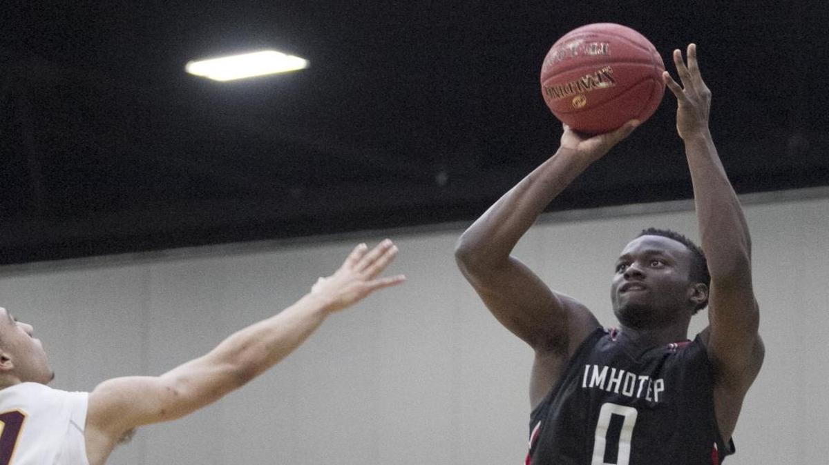 Imhotep's David Beatty shoots for three against Christ the King. Imhotep Charter (Pa.) trounced Christ the King (N.Y.) in game 9 of the Beachball Classic 73-34.
