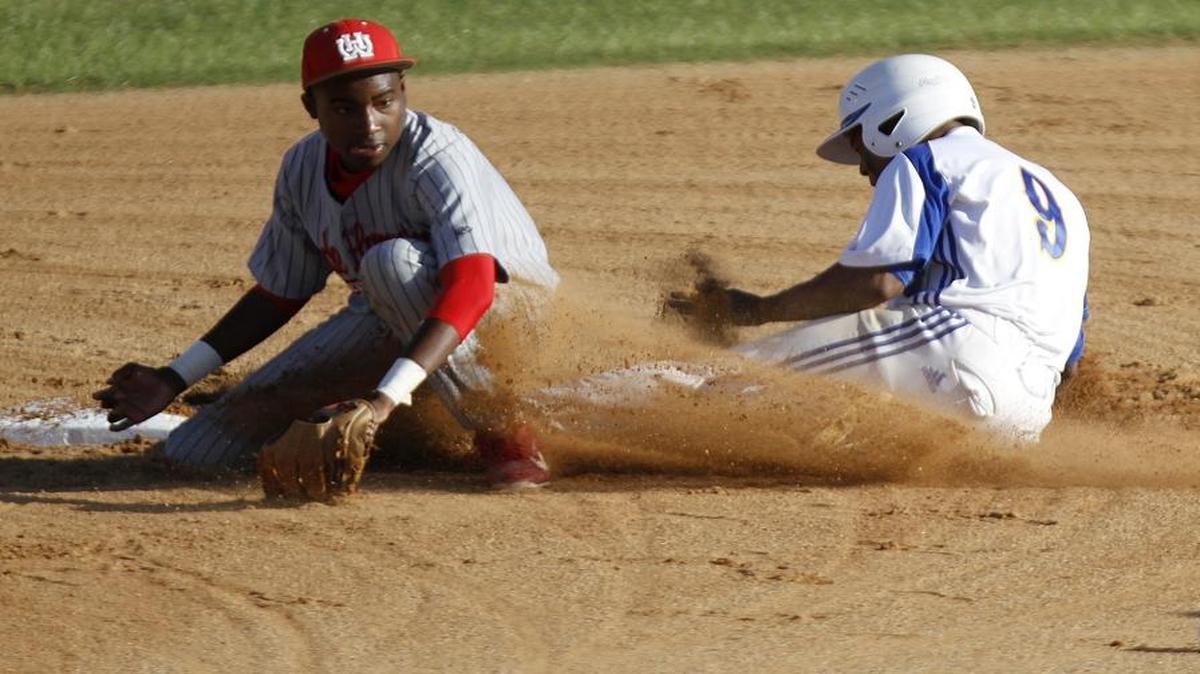 Loris High School’s Desmond Dozier (right) steals second base as the ball bounces away from Wade Hampton’s Eric Mulligan two years ago. The senior’s pursuit of a new state record was derailed last month, the result of a little-known rule.