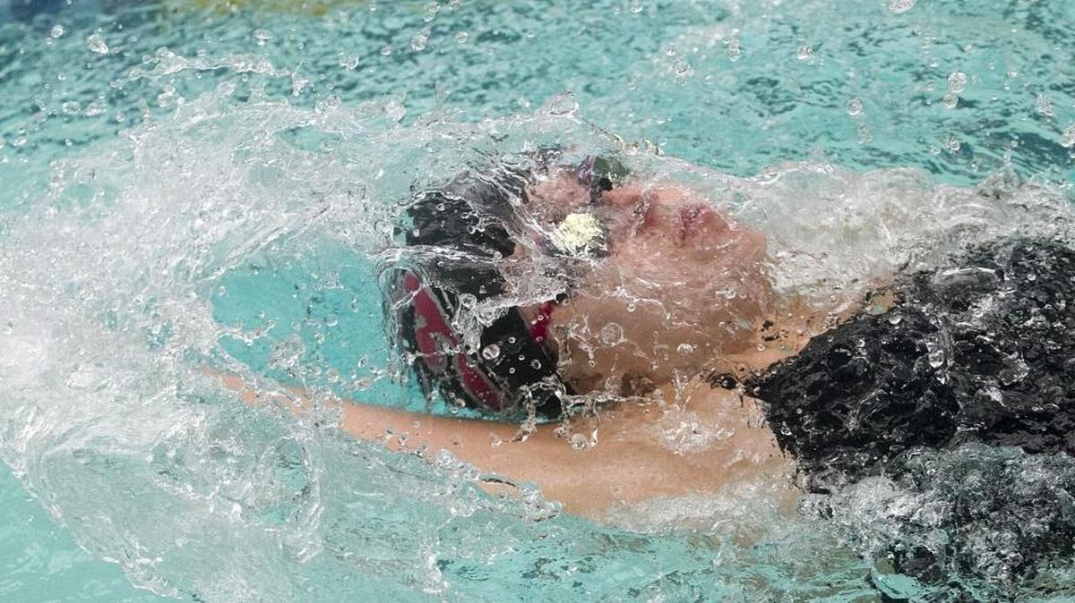 Water flows past Carolina Forest’s Peyton McWhorter as she does the backstroke during the Ripley’s Invitational in Myrtle Beach.