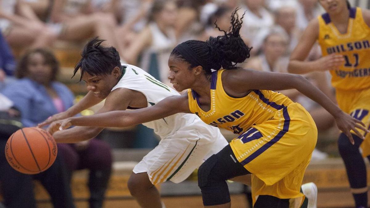 Myrtle Beach guard Keocia Walker (11) and Wilson guard Casma Washington (13) go for a loose ball during 1st half action Friday night at Myrtle Beach High School. The Seahawks defeated Wilson 59-35.