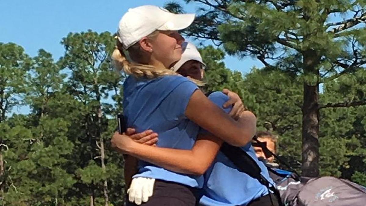 St. James’ Smith Knaffle (left) hugs a teammate Monday.