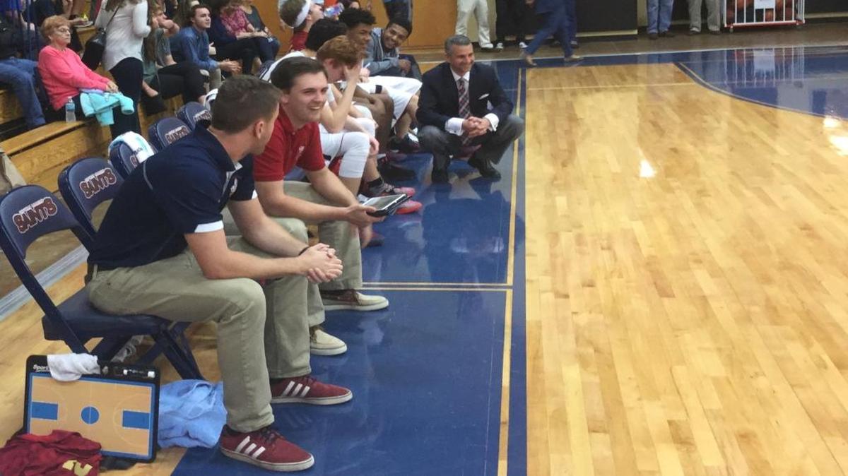Christian Academy of Myrtle Beach coach Darren Gore (crouching down) looks on during a game earlier this season.
