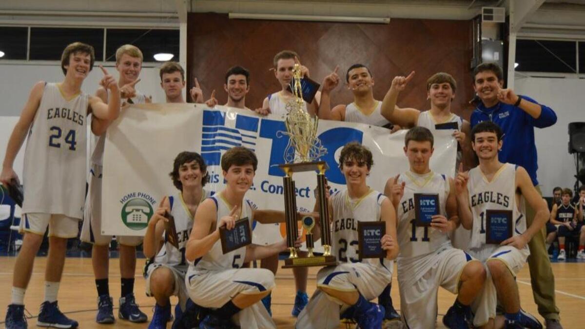 Pee Dee Academy poses with the trophy after winning the HTC Thanksgiving Tip Off Classic.