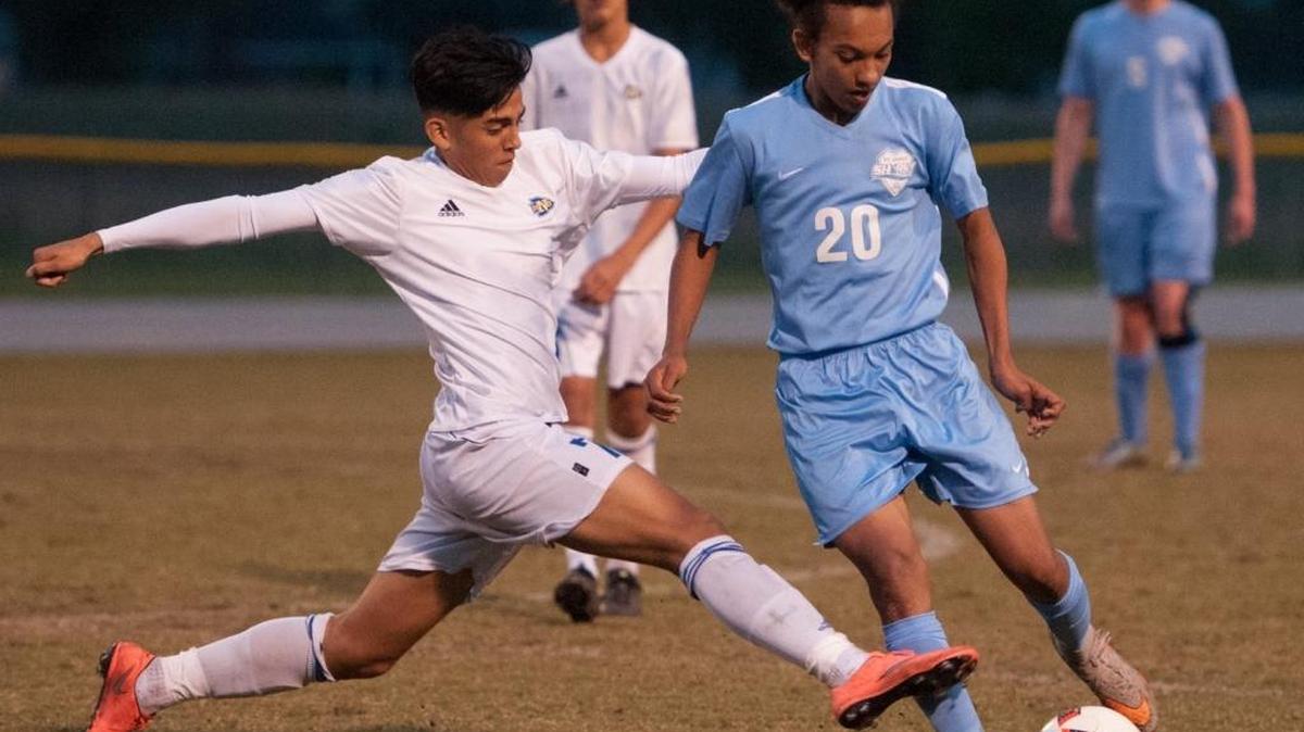 North Myrtle Beach’s Samir Cardoza (left) reaches for the ball as St. James’ William Weihrauch tries to keep control during a match last week.