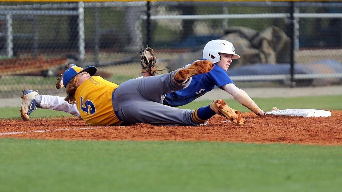 North Myrtle Beach’s Dylan Doolittle tags out St. James’ Jacob English during the meeting of Region VII-4A rivals on Tuesday.