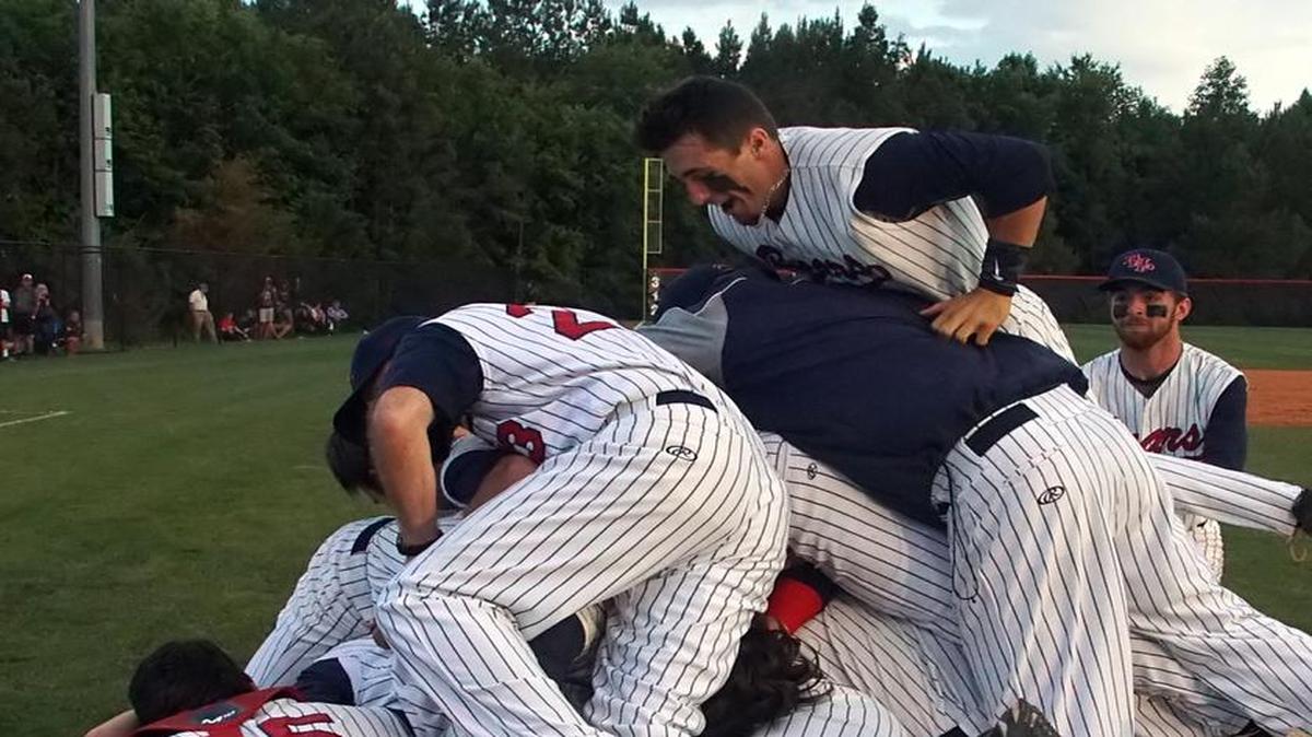 BHP team members dog pile each other after winning their second AAA State Championship in a row.