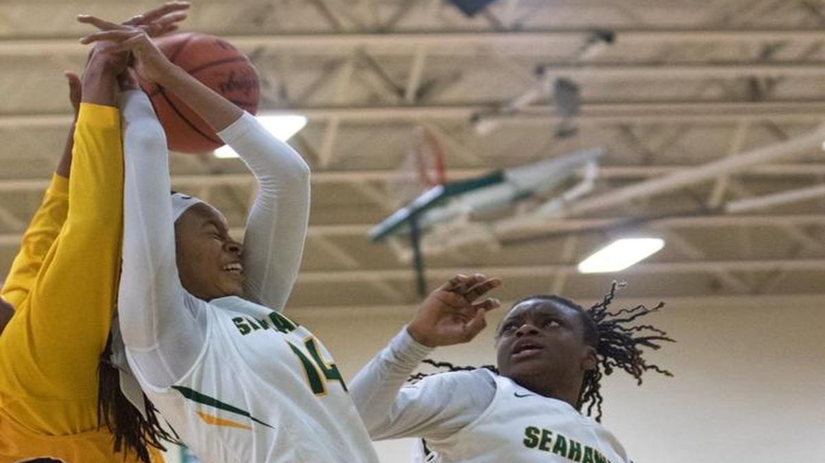 Myrtle Beach’s Nia Sumpter (center) and Wilson’s D’asia Gregg (left) fight for a rebound.