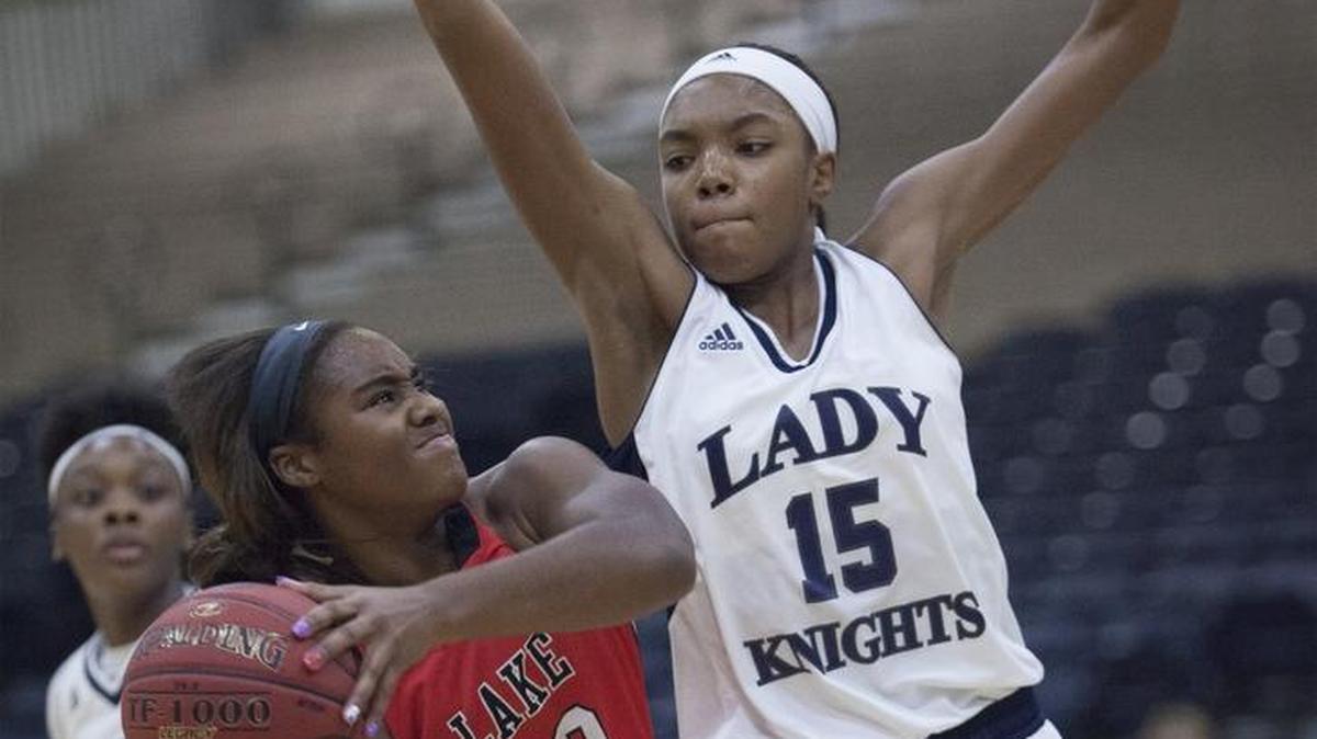 Lake Highland guard Jordan Lewis meets St. Francis’ Maya Dodson at the basket during Tuesday’s CresCom Bank Holiday Invitational tournament final.