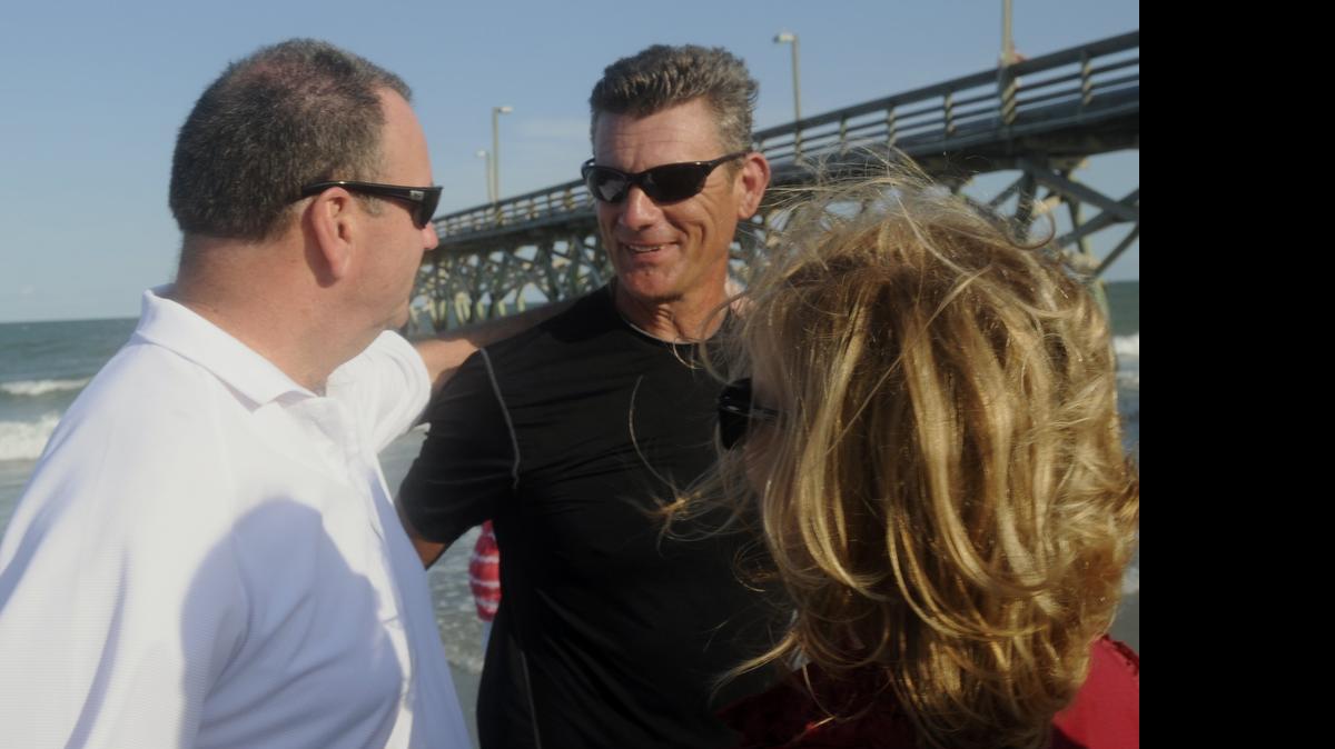 
Former Waccamaw tennis James Brown (center), with David and Melaine Grimes, talk after completing the Ashley G. Ride in 2012.
