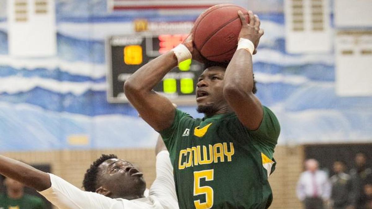 Conway's Juwan Moody launches for the goal to score on Thursday. The Conway Tigers clawed past the Socastee Braves 56-38 in Socastee on Thursday night, Jan. 26, 2017.