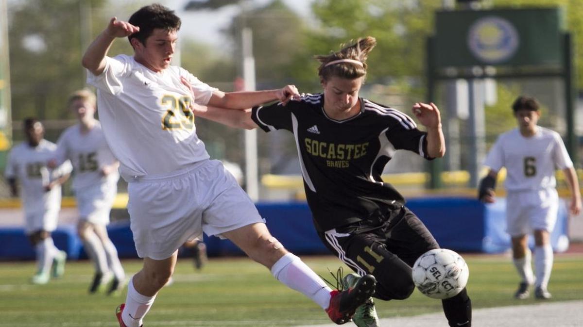 Myrtle Beach’s Bryce Sobota competes for the ball with Socastee’s Chris Matlashewki during last year’s Soccer at the Beach tournament.