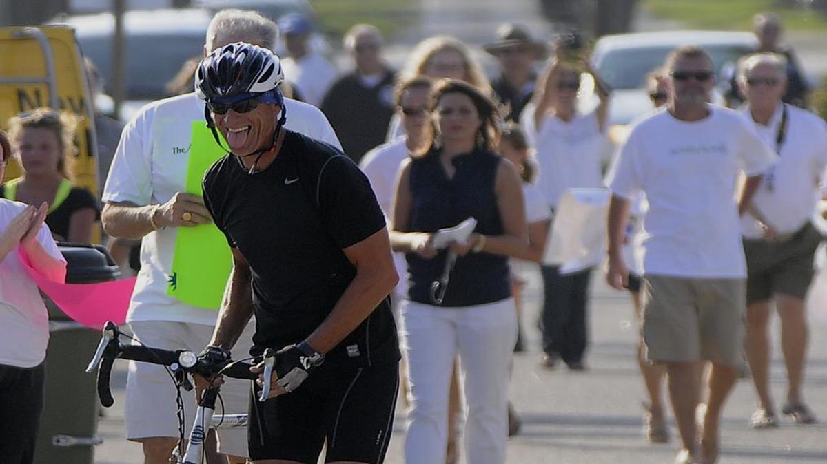James Brown celebrates with family and friends at the Surfside Beach Pier after completing a coast-to-coast bicycle ride in memory of Ashley Gaines, who passed away after a battle with cancer in 2008.