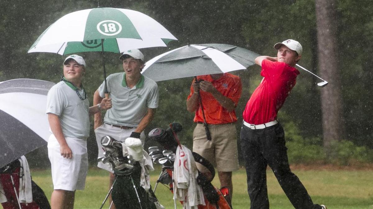 Waccamaw’s Patrick Golden drives the ball in a downpour during the Class AA state golf championship at True Blue Plantation.