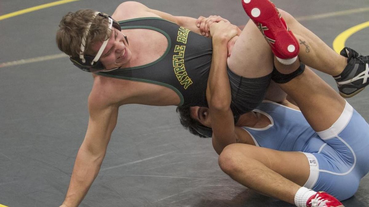 Myrtle Beach's Damien Biviano tries to resist being dragged down by St. James' Uriel Mauricio. Myrtle Beach Seahawk boys hosted the St. James Sharks in boys wrestling on Tuesday night. The Sharks bested the Seahawks 49-28.
