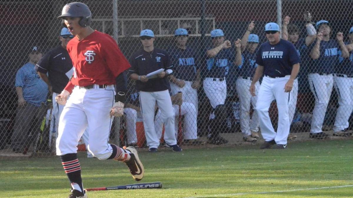 Strom Thurmond’s Payton Smith approaches home plate after his Grand Slam in the first inning of Game 2 of the Class AA state championship series as the Aynor dugout looks on.